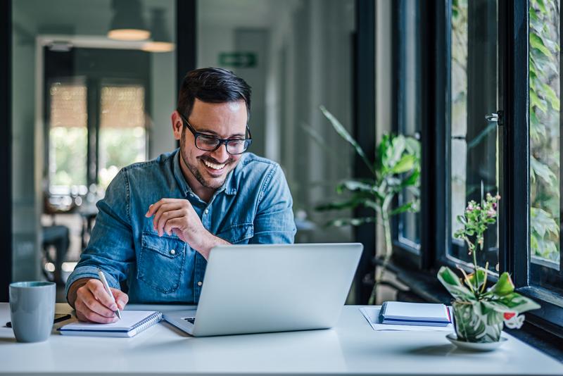 Man reading FAQs on his laptop