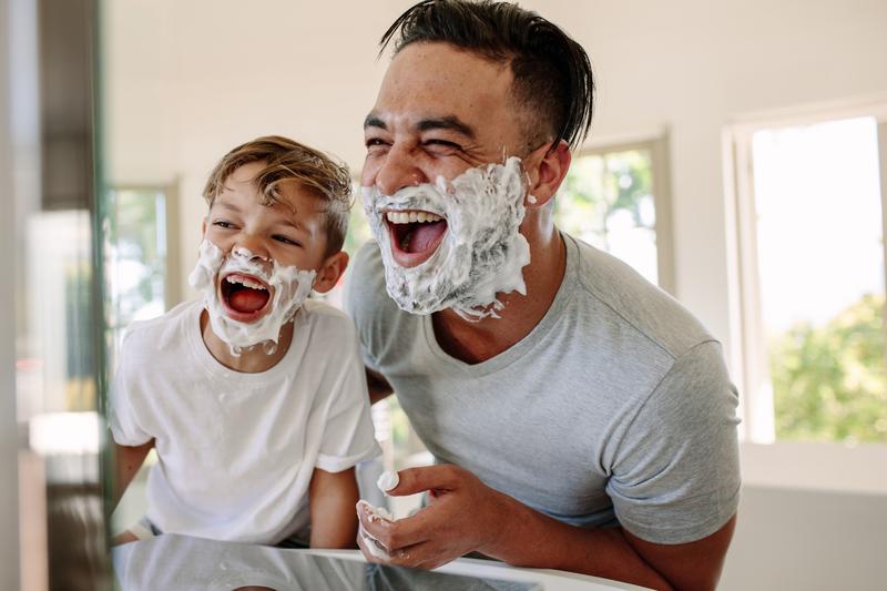 Image: father and son having fun while shaving in bathroom.