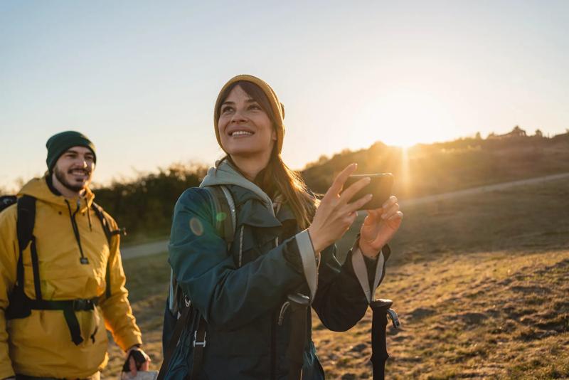 hiker using smartphone during outdoor excursion