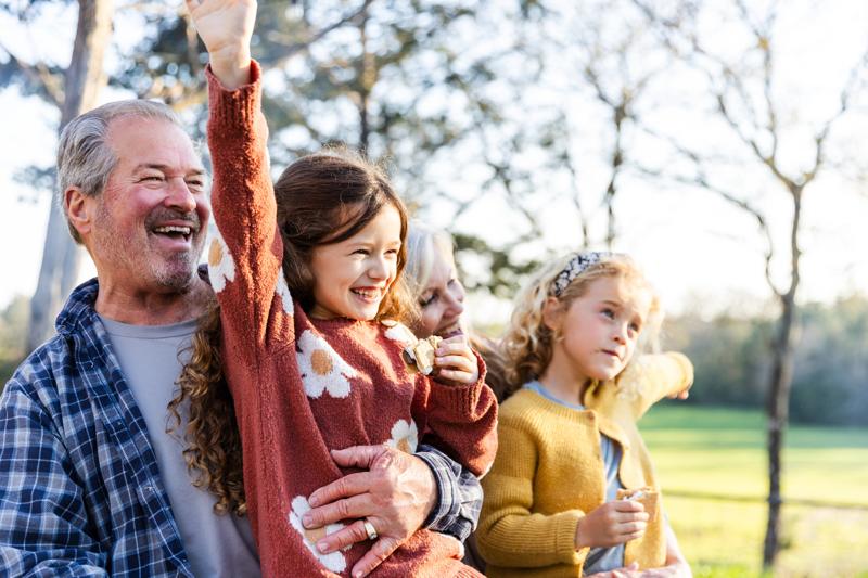 grandparents and granddaughters pose for silly photo
