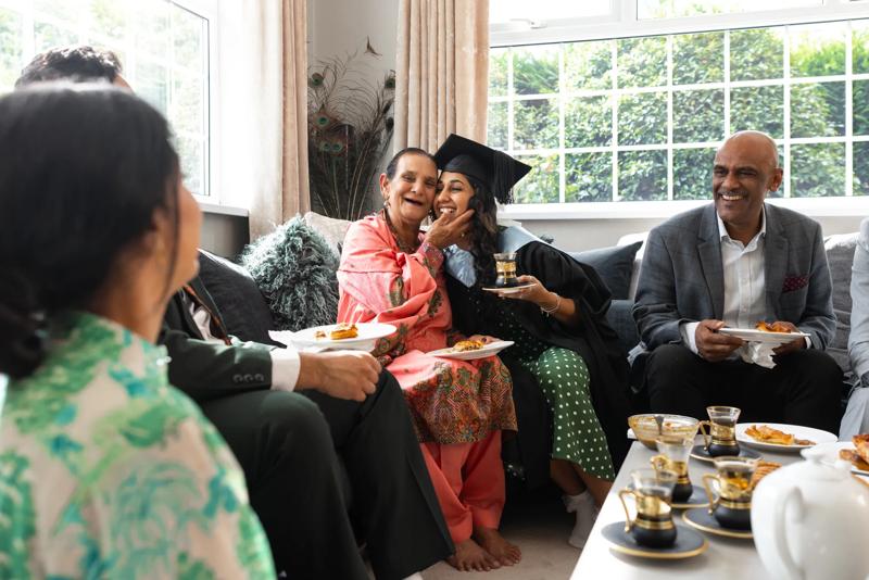 graduate celebrating achievement with family at home