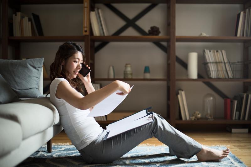 oman sitting on floor taking phone call