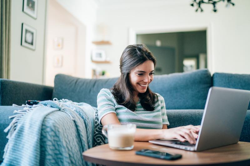 woman smiling working on laptop.