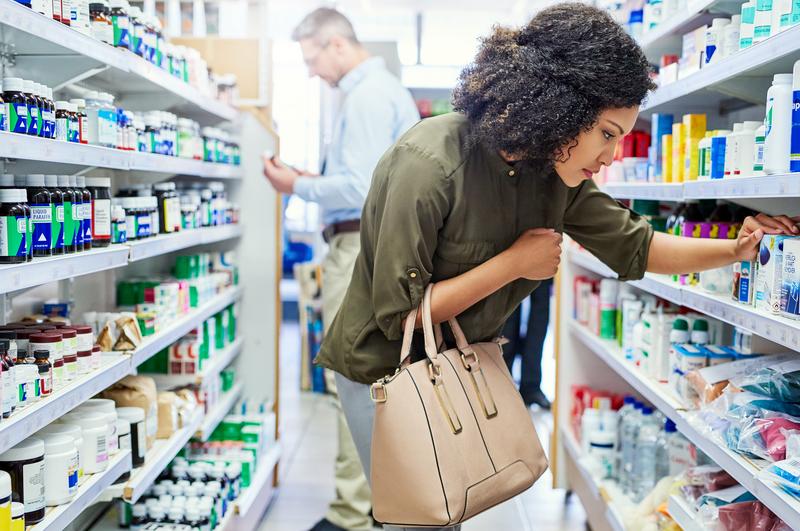 woman browsing pharmacy shelves.