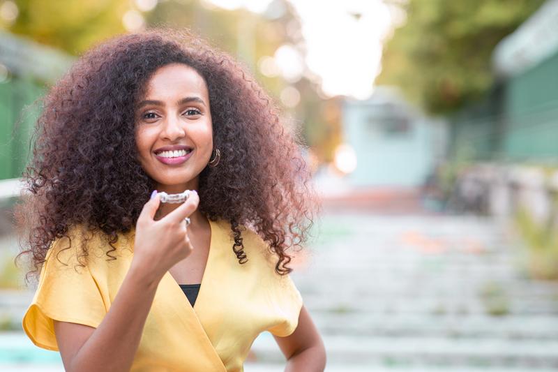 Woman holding a dental appliance .
