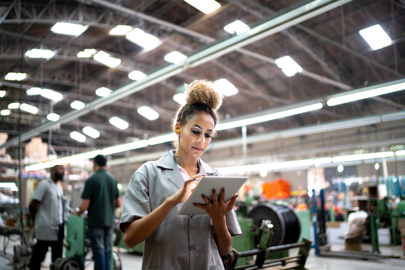 woman with tablet in industrial setting