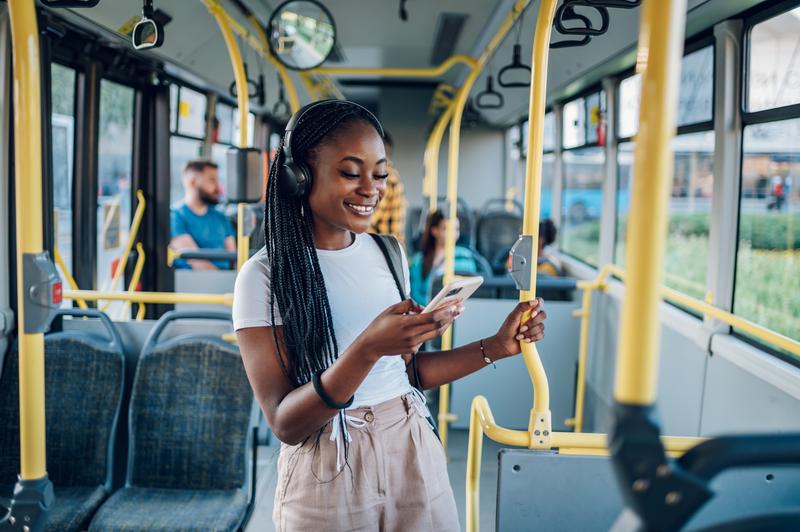 Woman standing on a bus.