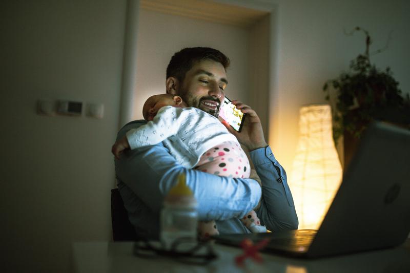 young father working at home with his infant girl.