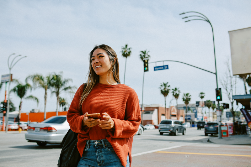 smiling woman walking the streets of Los Angeles