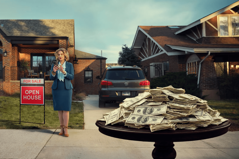 open house with for sale sign and table stacked with cash