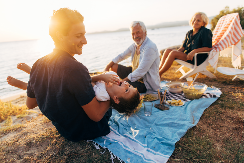 multi-generation family having a picnic on the beach