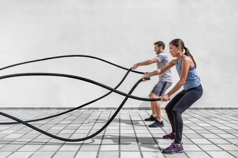 Two people using gym ropes
